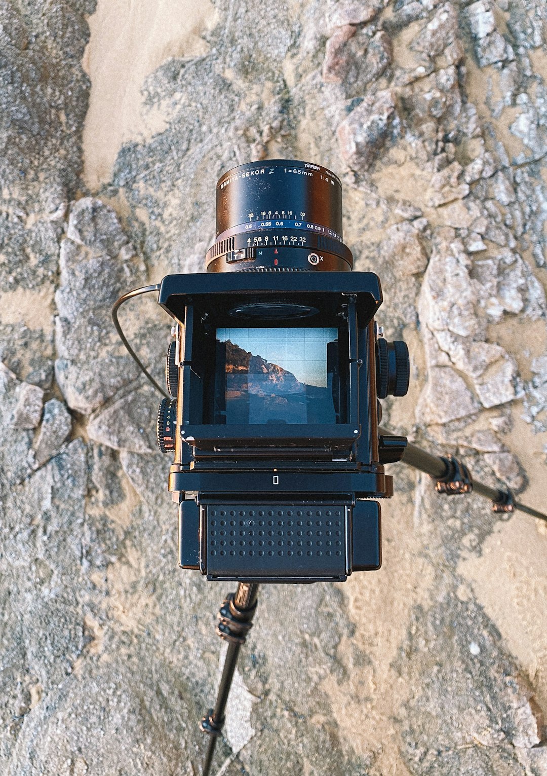 Vintage film camera mounted on a tripod in a production studio